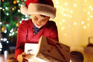 boy opening a Christmas present boy opening a Christmas present