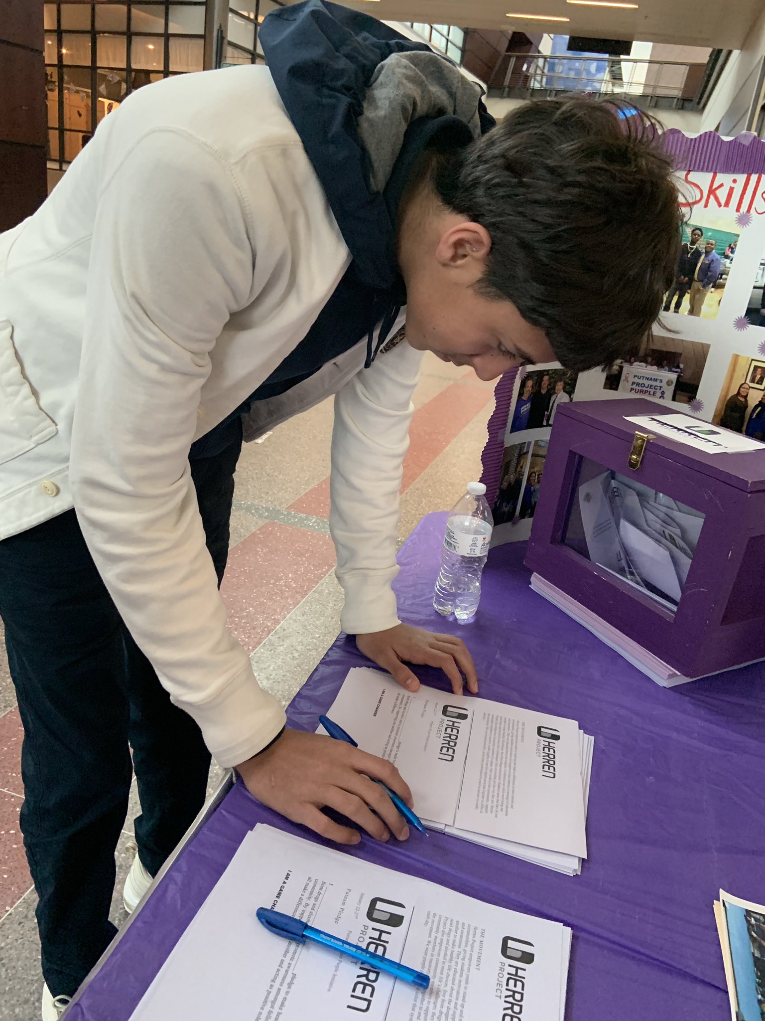 Roger l Putnam vocational academy Springfield Massachusetts goes purple putnam academy student signing Herren Project clubs pledge to be substance free